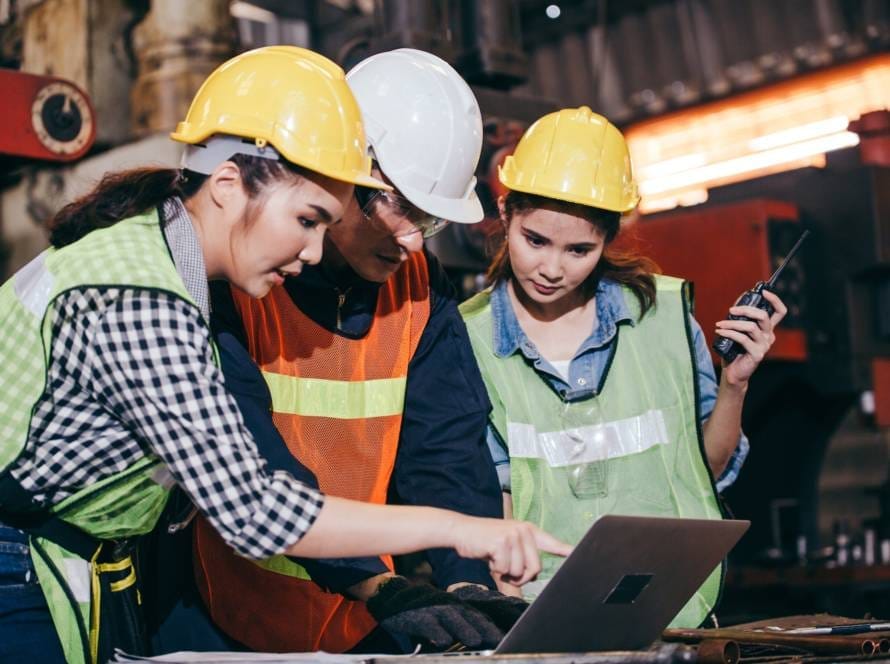Asian engineer foreman training trainee working on factory system
