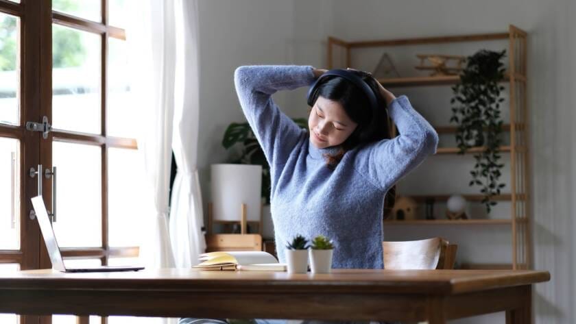 Asian woman raise hand while learning online with tablet at home