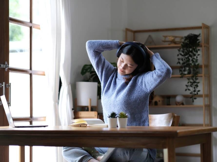 Asian woman raise hand while learning online with tablet at home