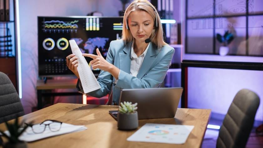 Business woman using headset and laptop for video call