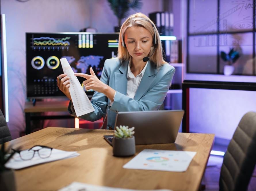 Business woman using headset and laptop for video call