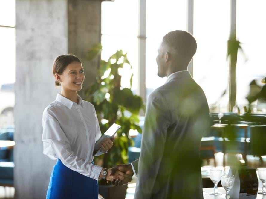 Pretty business lady shaking hand of business partner