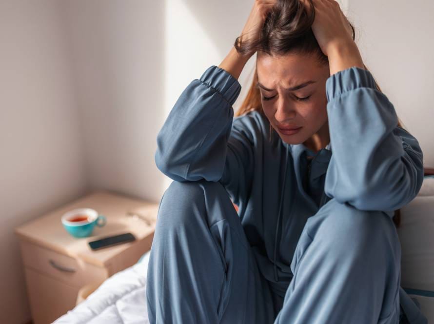 Anxious woman crying in bed