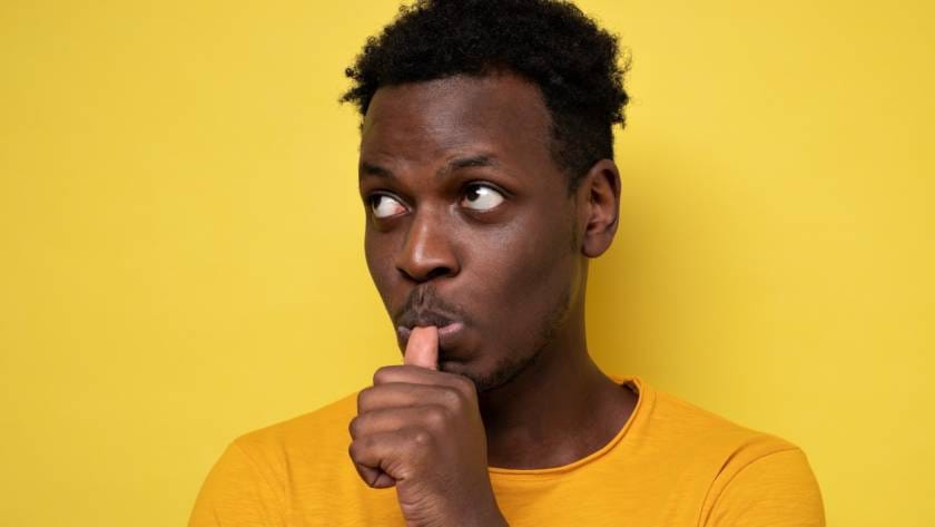 Man with finger in mouth sucking thumb or biting fingernail in stress