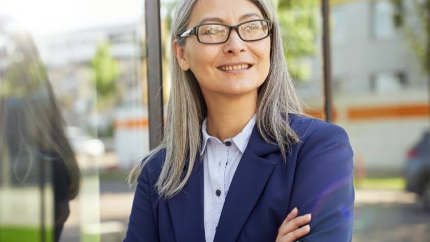 Positive female employee smiling and posing for camera