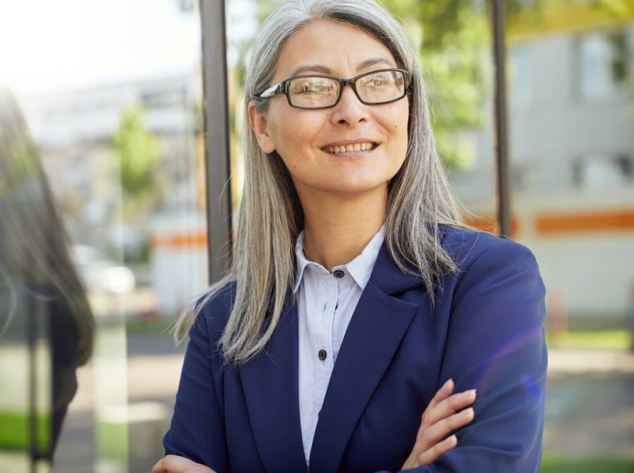 Positive female employee smiling and posing for camera